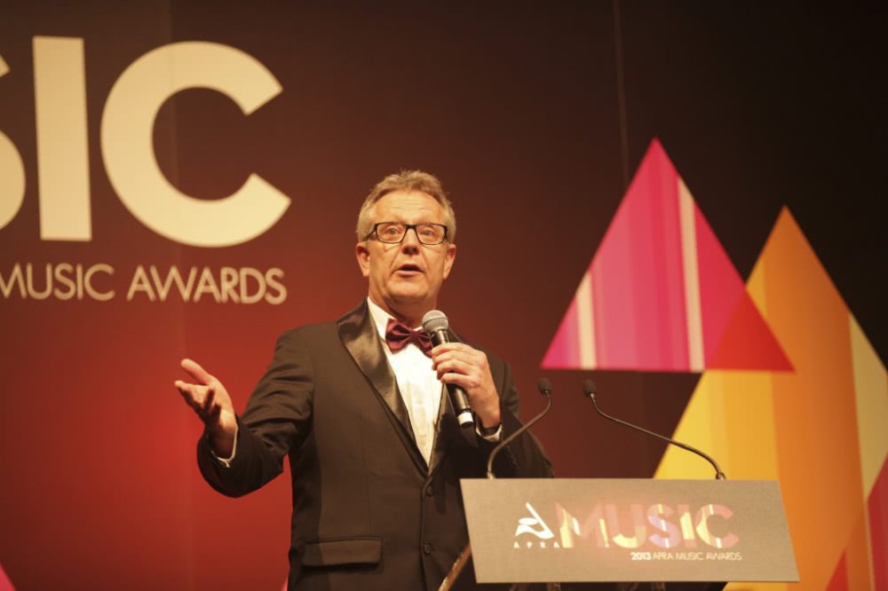 APRA Awards host Jonathan Biggins 2013 behind lecturn