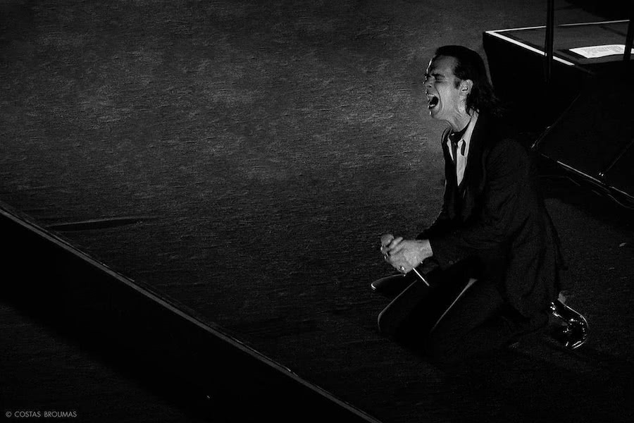 nick cave on stage black and white