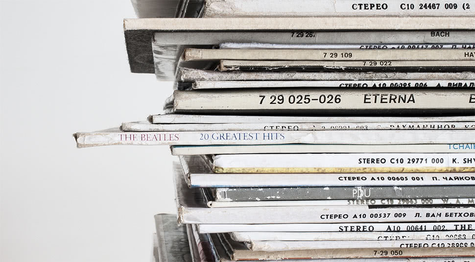 A stack of vinyl albums (including a Beatles' Greatest Hits album), likely released on major labels